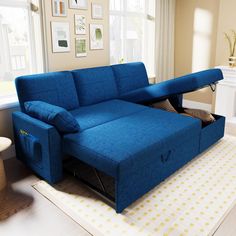 a blue couch with a pull out bed underneath it