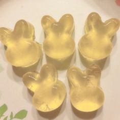 four yellow soaps shaped like animals on a plate