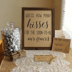 there is a sign that says guess how many kisses for the son - to - be