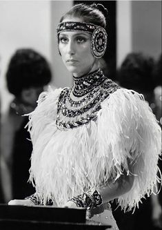 a woman in a feathered dress and headpiece