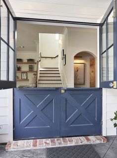 the entrance to a house with blue doors