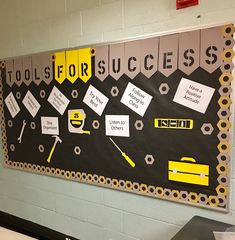 a bulletin board with tools for success written in yellow and black on it's side