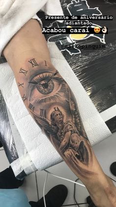 a person with a tattoo on their arm that has an eye and clock in it