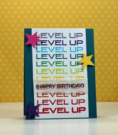 a handmade birthday card with the words level up written on it and stars in different colors