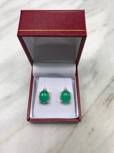 Featured here is a magnificent set of 8.50 total carat weight, cabochon-cut emerald & diamond studs in fine 14K yellow gold. Displayed are medium-green emeralds with very good transparency, accented by brilliant round diamonds in a simple four-prong gold mount, allowing for the emerald to be shown in full view. The earth mined, green emeralds have a desirable lush green color with excellent qualities. These earrings are ideal for everyday use and are the perfect accessory to any outfit. Emer Fine Jewelry Cabochon Gemstones For Formal Occasions, Formal Fine Jewelry Cabochon Gemstones, Fine Jewelry Green Cabochons For Formal Occasions, Green Cabochons For Formal Fine Jewelry, Formal Fine Jewelry Gemstone Cabochons, Green Gemstone Cabochons For Formal Use, Exquisite Formal Gemstone Cabochons, Elegant Yellow Gold Cabochons For Wedding, Luxury Green Oval Earrings