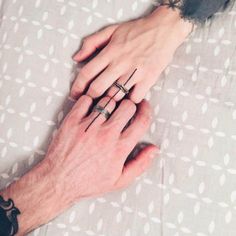 two hands holding each other with rings on their fingers