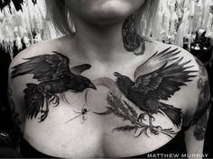 a woman with tattoos on her chest and two birds