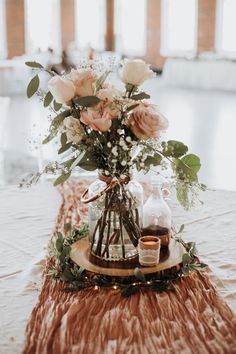 a table with flowers and bottles on it