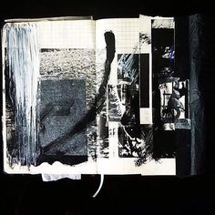 an open book with black and white pictures on it's cover, in the dark