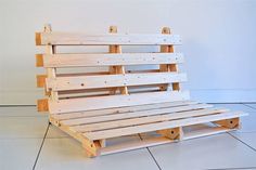 a wooden bench sitting on top of a tiled floor