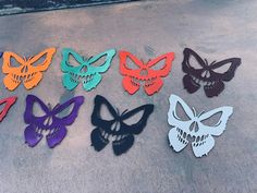 six different colored paper butterflies with skulls on them, all in the same color and shape