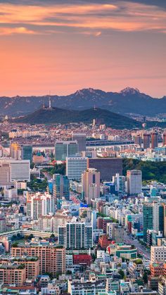 an aerial view of the city with mountains in the background