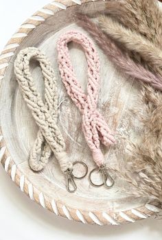 two pairs of pink and white knitted lanyards on a plate