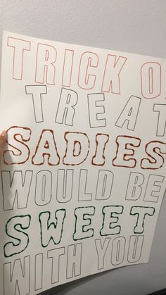 someone holding up a sign that says trick or treat at sadies would be sweet with you