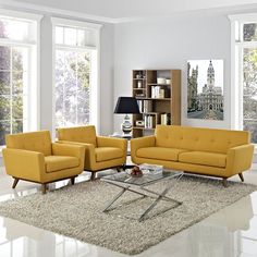 a living room filled with yellow furniture and lots of window sill space in front of them