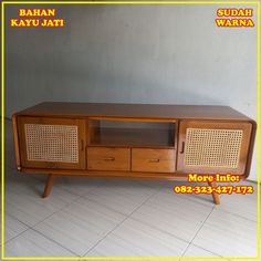 the sideboard has two drawers and is made from wood with rattan weaves