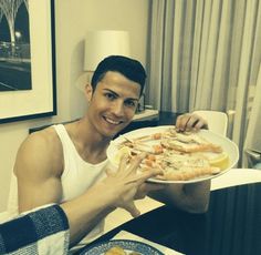 a man sitting at a table with a plate of food