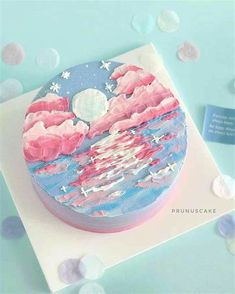 the cake is decorated with pink and blue icing