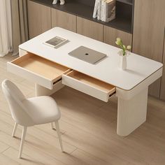 a white desk with two drawers and a laptop on it in front of a bookshelf