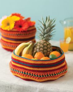 two baskets filled with fruit sitting on top of a table