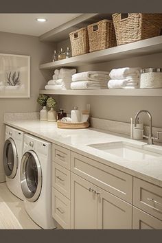 a washer and dryer in a small room with shelves above the washer