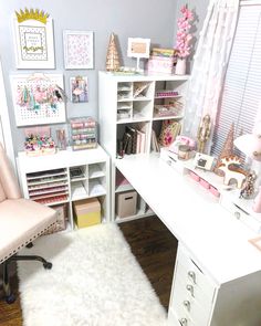 a white desk topped with lots of drawers next to a window filled with pink curtains