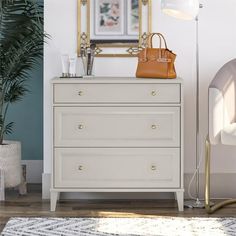 a white dresser with a handbag on top