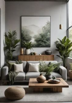 a living room filled with lots of plants next to a large painting on the wall