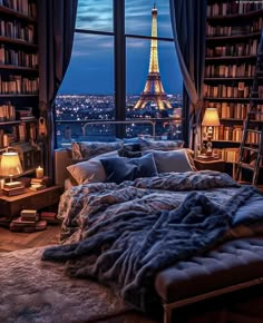 a bedroom with a view of the eiffel tower in paris, france at night