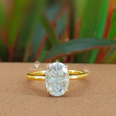 a close up of a ring with a diamond in the center on a brown surface