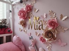 a child's bedroom decorated with pink and gold paper flowers