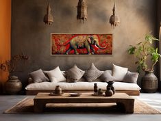 a living room with an elephant painting on the wall and couches in front of it