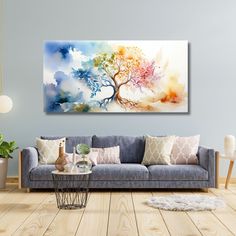 a living room scene with a couch and painting on the wall above it's coffee table