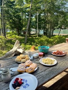 a picnic table with plates of food on it