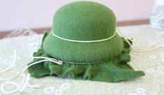 a green hat sitting on top of a table