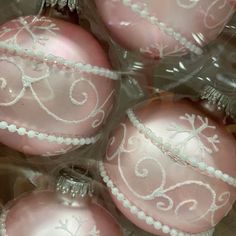 pink ornaments are wrapped in clear plastic