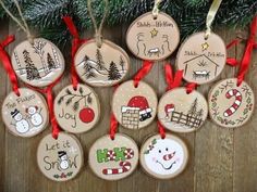 christmas ornament ornaments hanging on a wooden table next to a fir tree with red ribbon