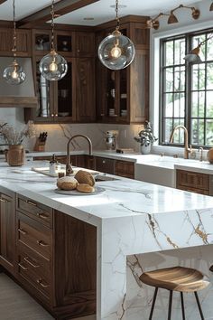 a large kitchen with marble counter tops and wooden cabinets, along with two bar stools