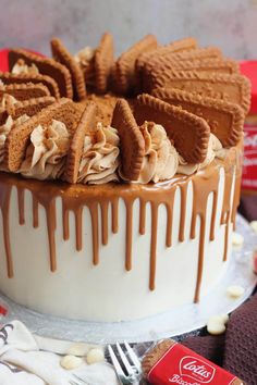 a close up of a cake on a table with candy and cookies in the background