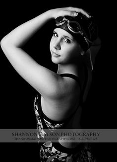 black and white photograph of a woman in swimsuit with goggles on her head