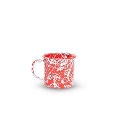 a red and white mug sitting on top of a table