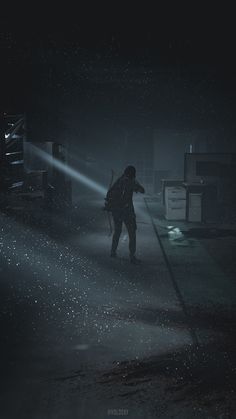 a person standing in the dark with a backpack on their back and flashlight shining through