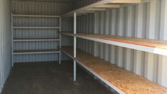 an empty storage room with shelves in it