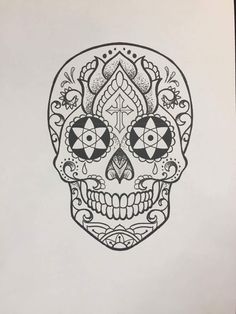 a black and white drawing of a skull with ornate designs on it's face