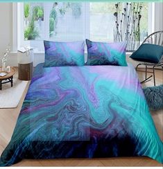 a bed covered in a blue and purple comforter