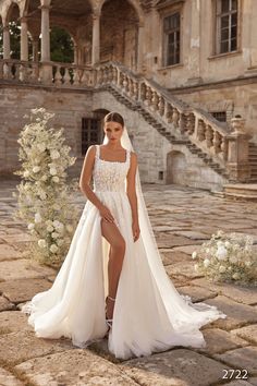 a woman in a white wedding dress posing for the camera with her legs crossed and wearing high heels