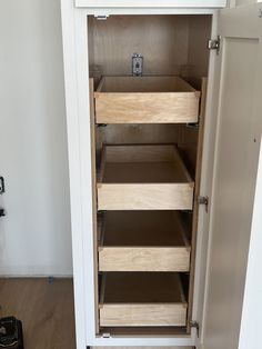 an open cabinet with drawers in a room