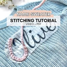 a blue sweater with the words name sweater stitching on it and a pink string hanging from