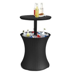 two tiered table with drinks and bottles on the top, sitting next to each other