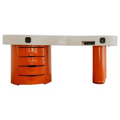 an orange and white desk with three drawers